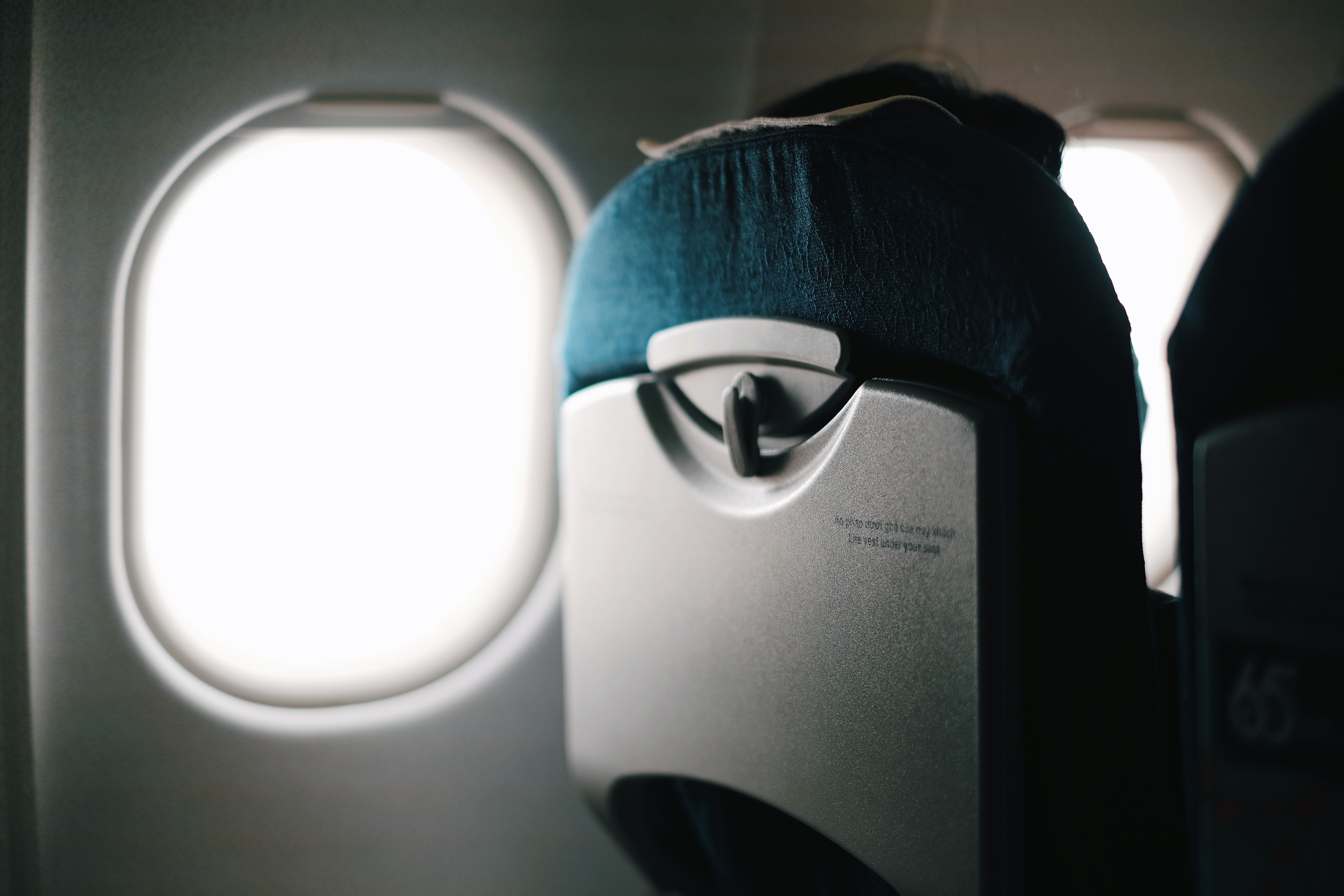 Emirates business class window seat with city skyline view and fully reclined lie-flat bed