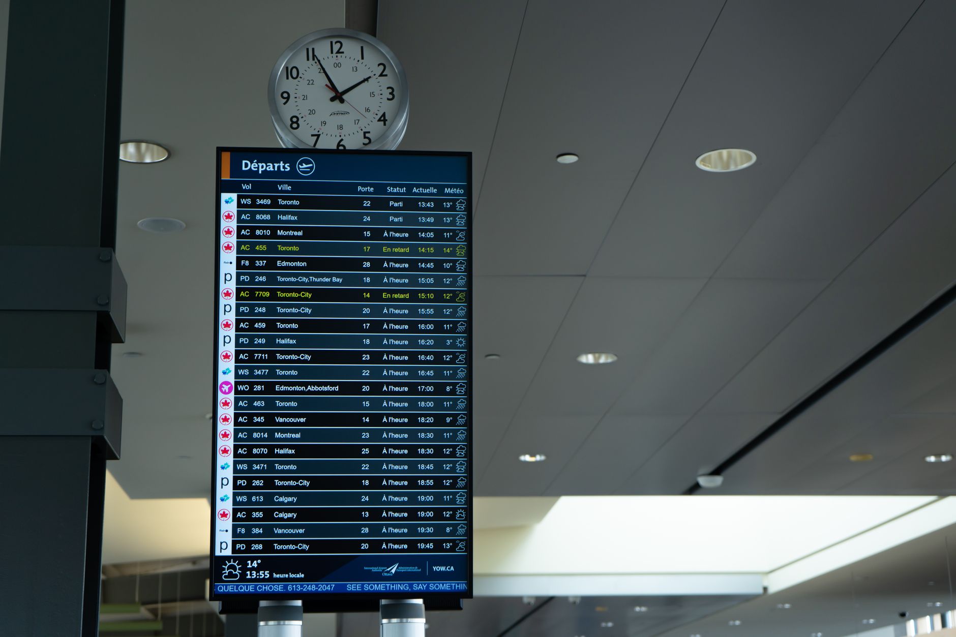 Passenger reviewing departure board in bright airport terminal