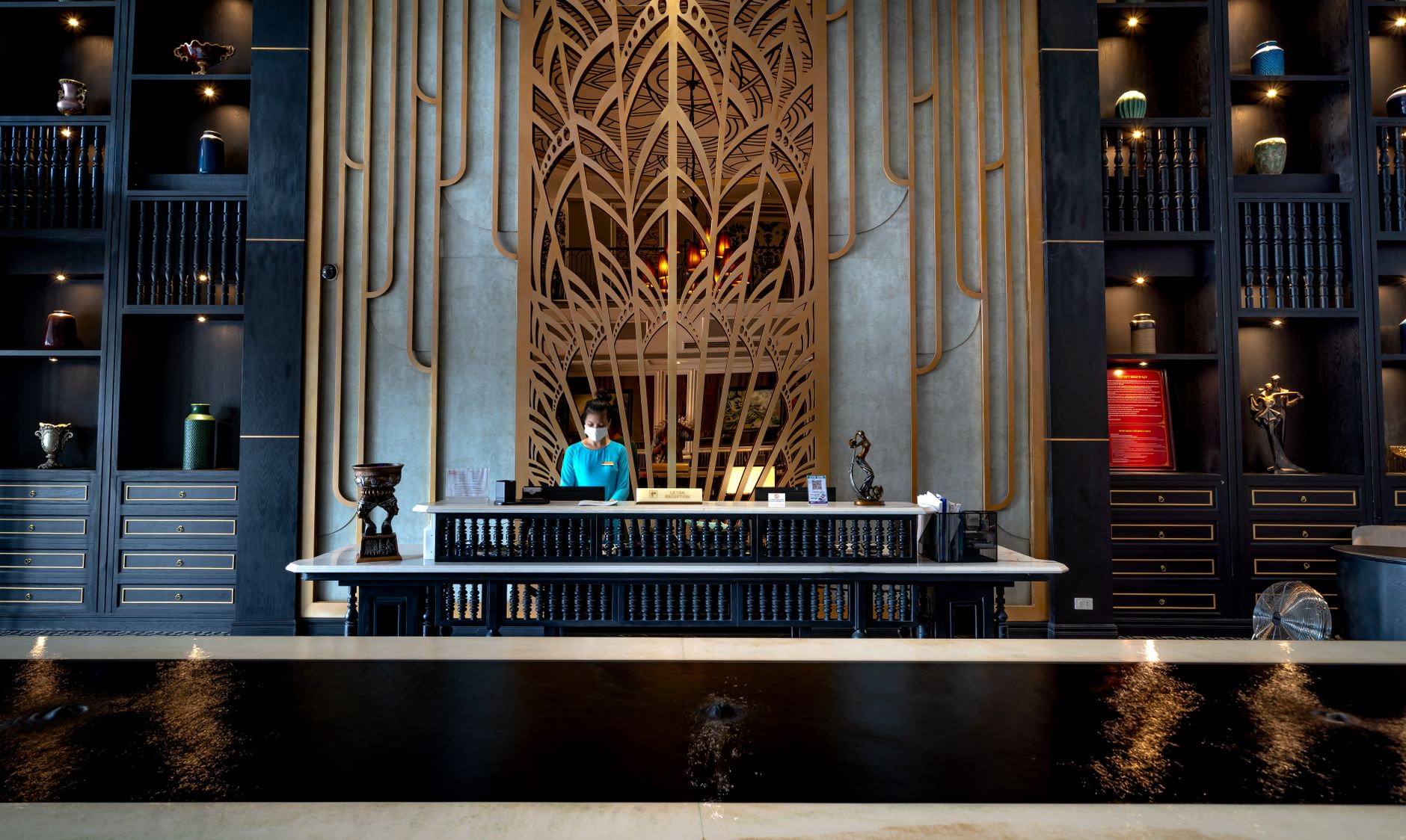 Traveler receiving printed receipt at hotel front desk