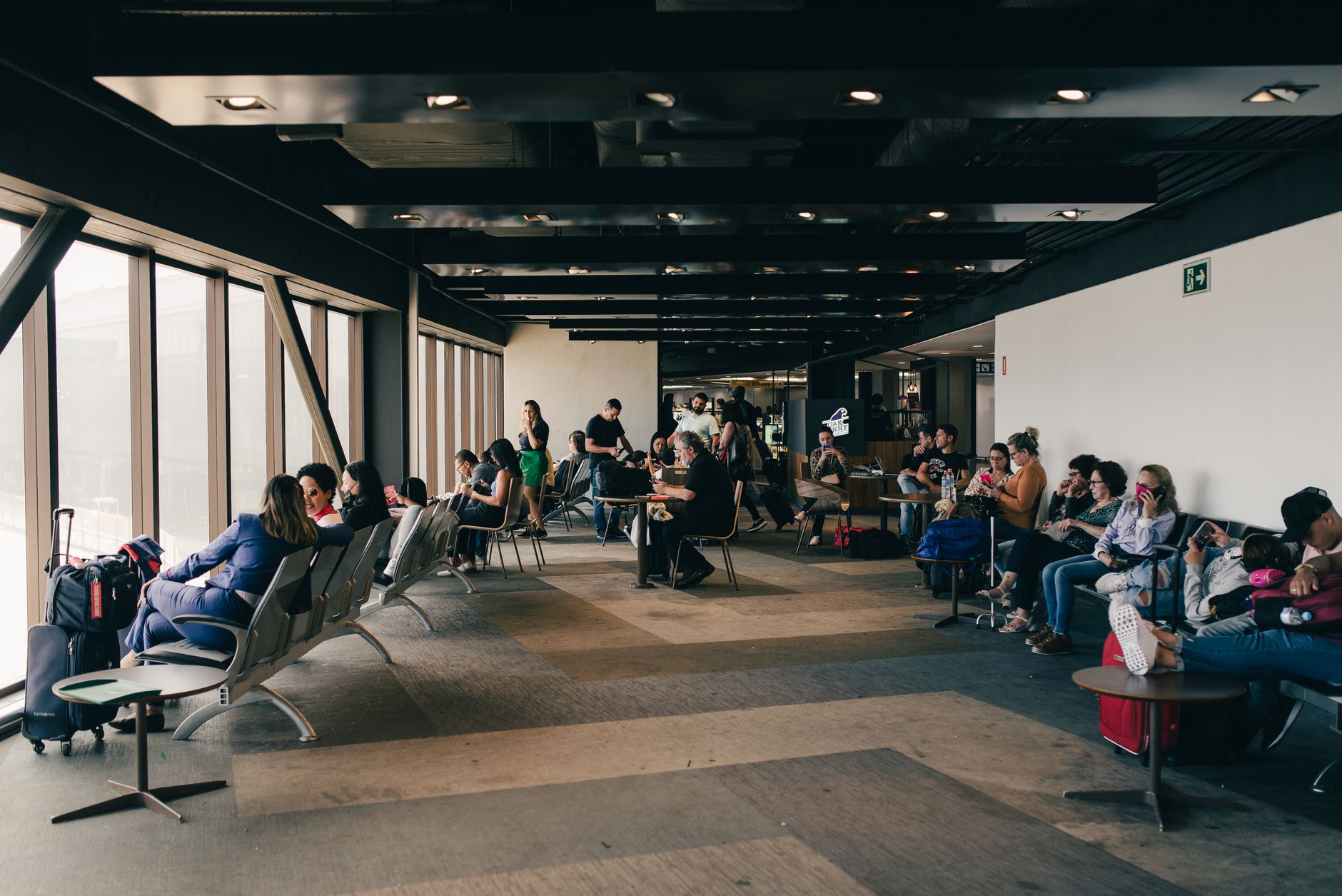 Passenger sitting in bright airport terminal waiting area