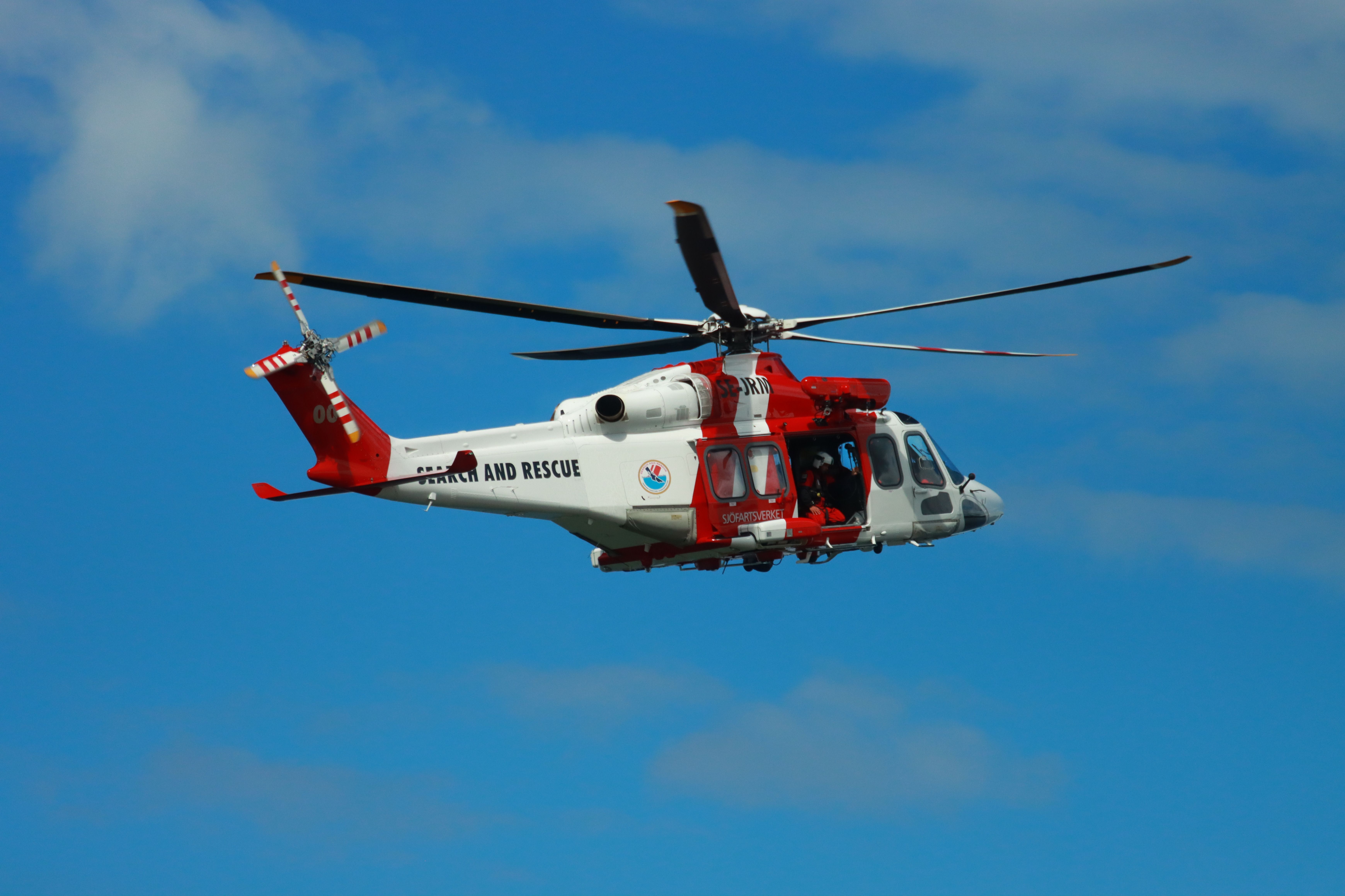 Medical evacuation helicopter landing on a remote mountain terrain during an emergency rescue operation