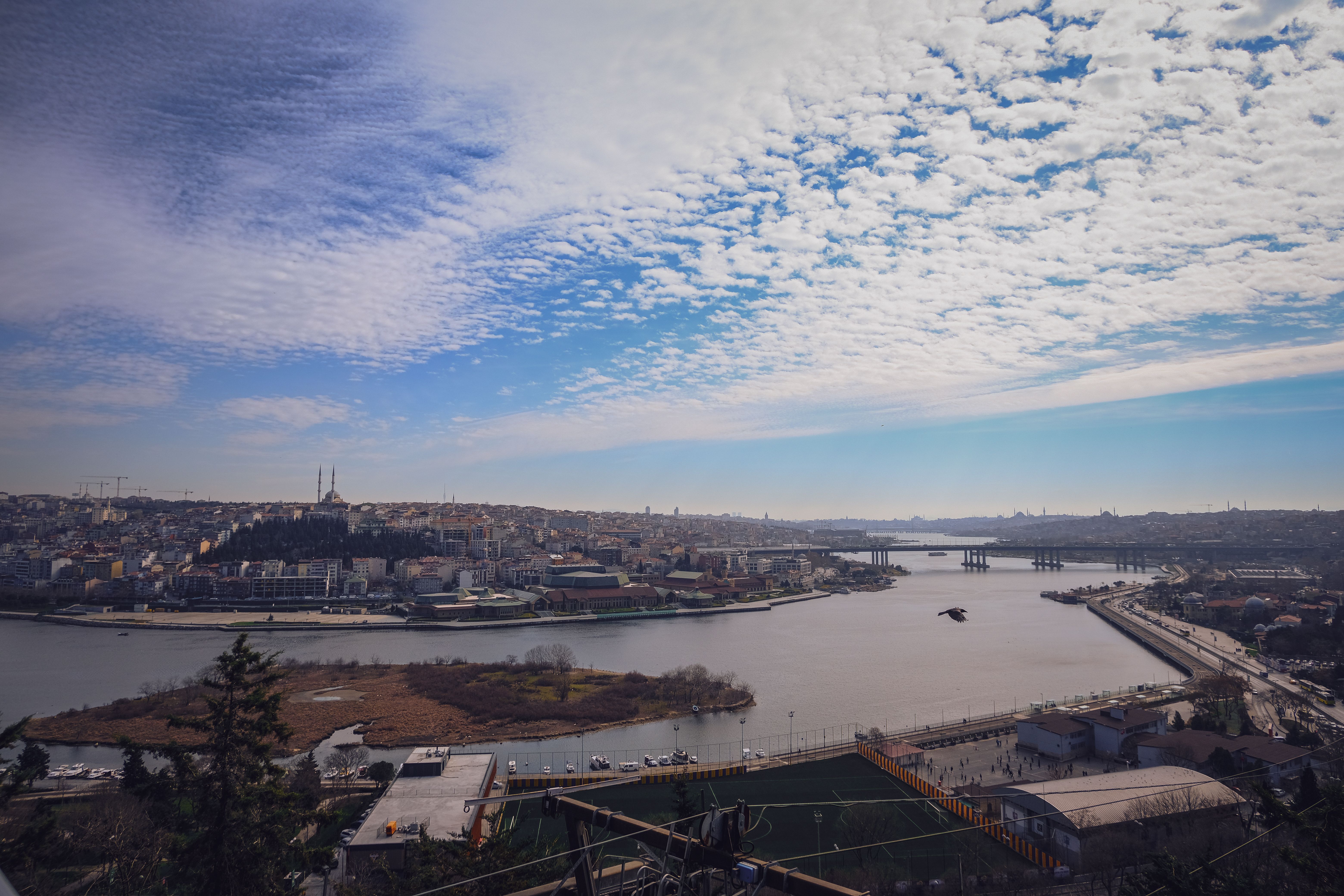 The Süleymaniye Mosque perched on Istanbul's Third Hill with its cascading Ottoman domes and minarets silhouetted against a golden sky, the Golden Horn and Bosphorus visible below
