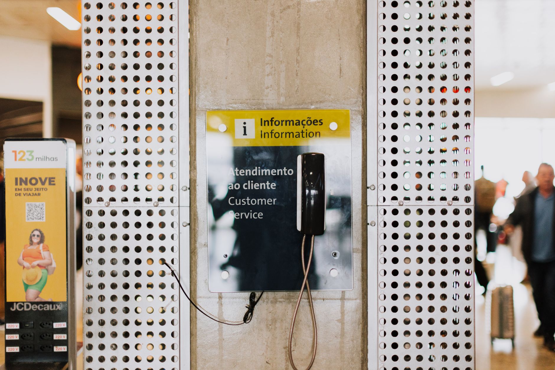 Passenger at information desk in bright transit station