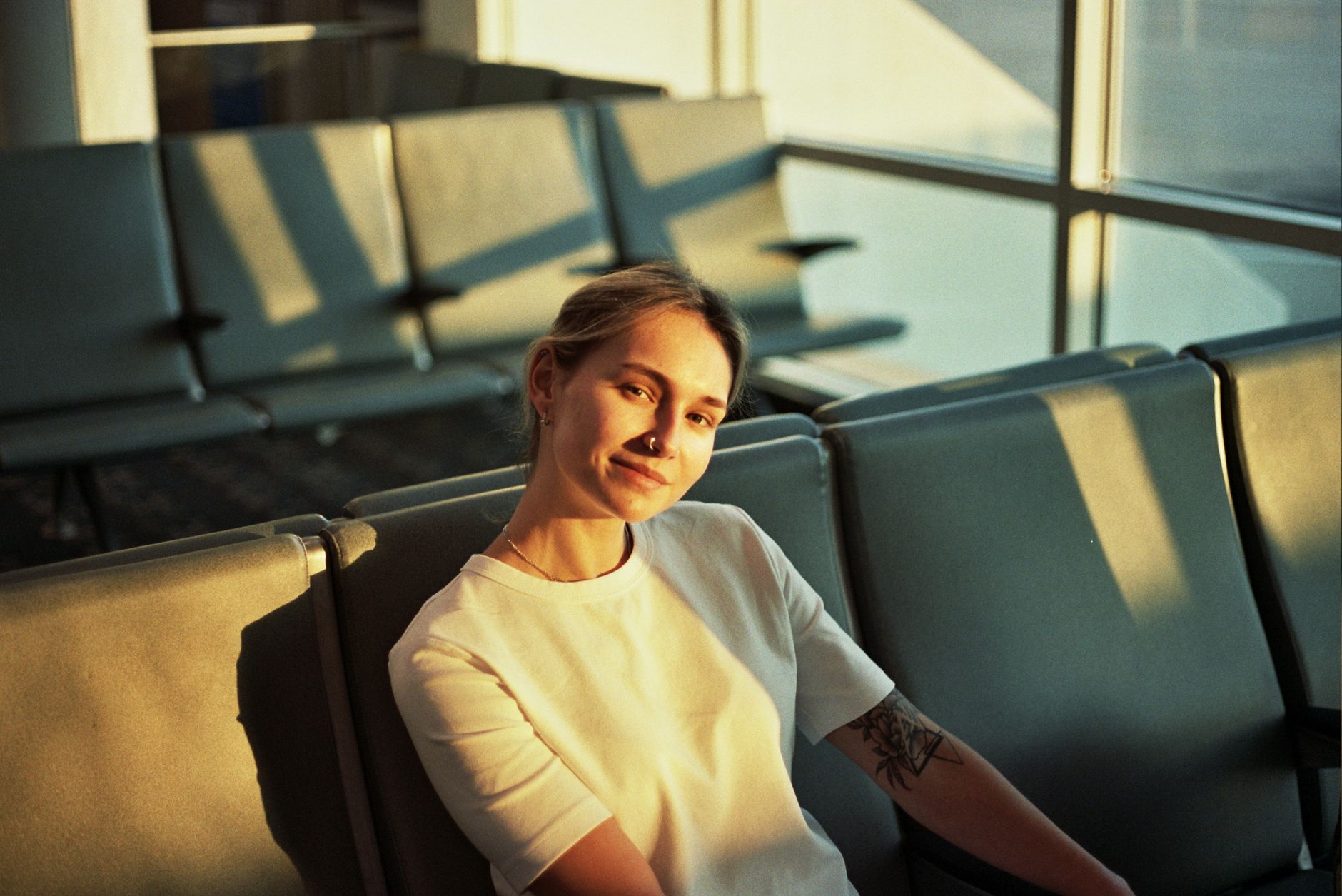 Woman working on laptop in airport terminal