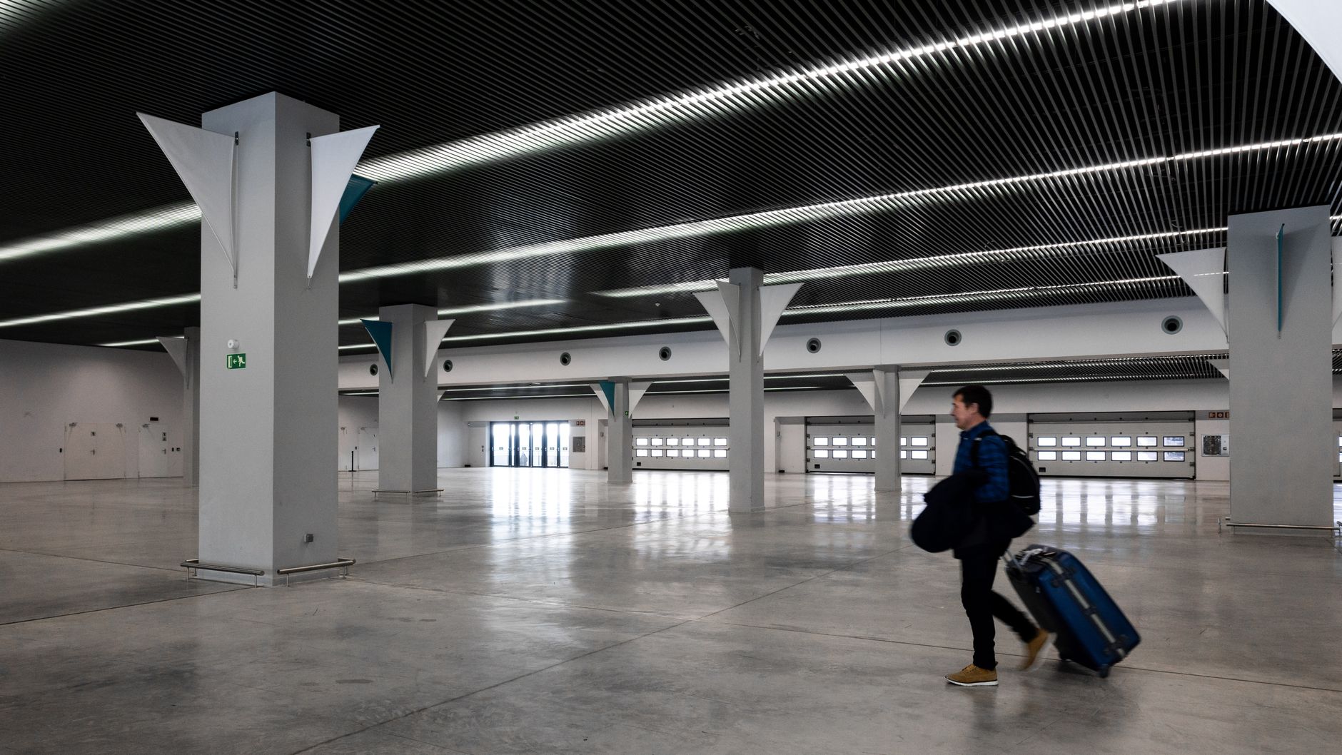 Confident traveler walking through bright airport terminal