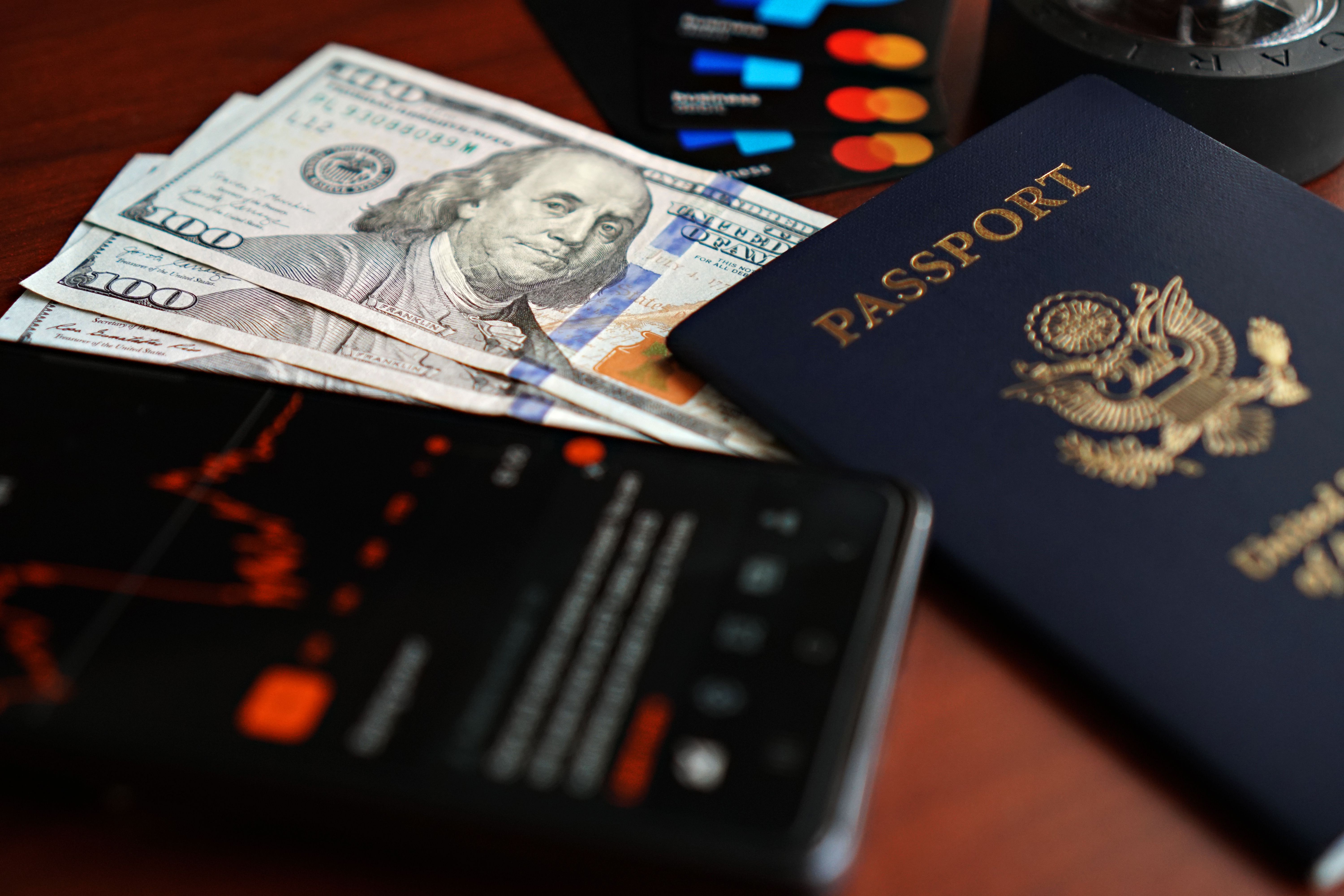 Premium travel rewards credit card resting on an open passport with foreign currency visible underneath