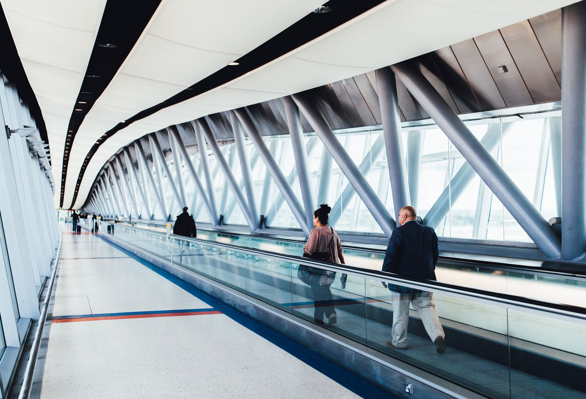 Traveler walking through O'Hare Airport concourse during connection