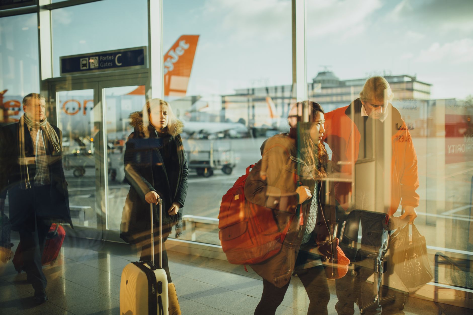 Business traveler sitting calmly with briefcase in bright airport terminal