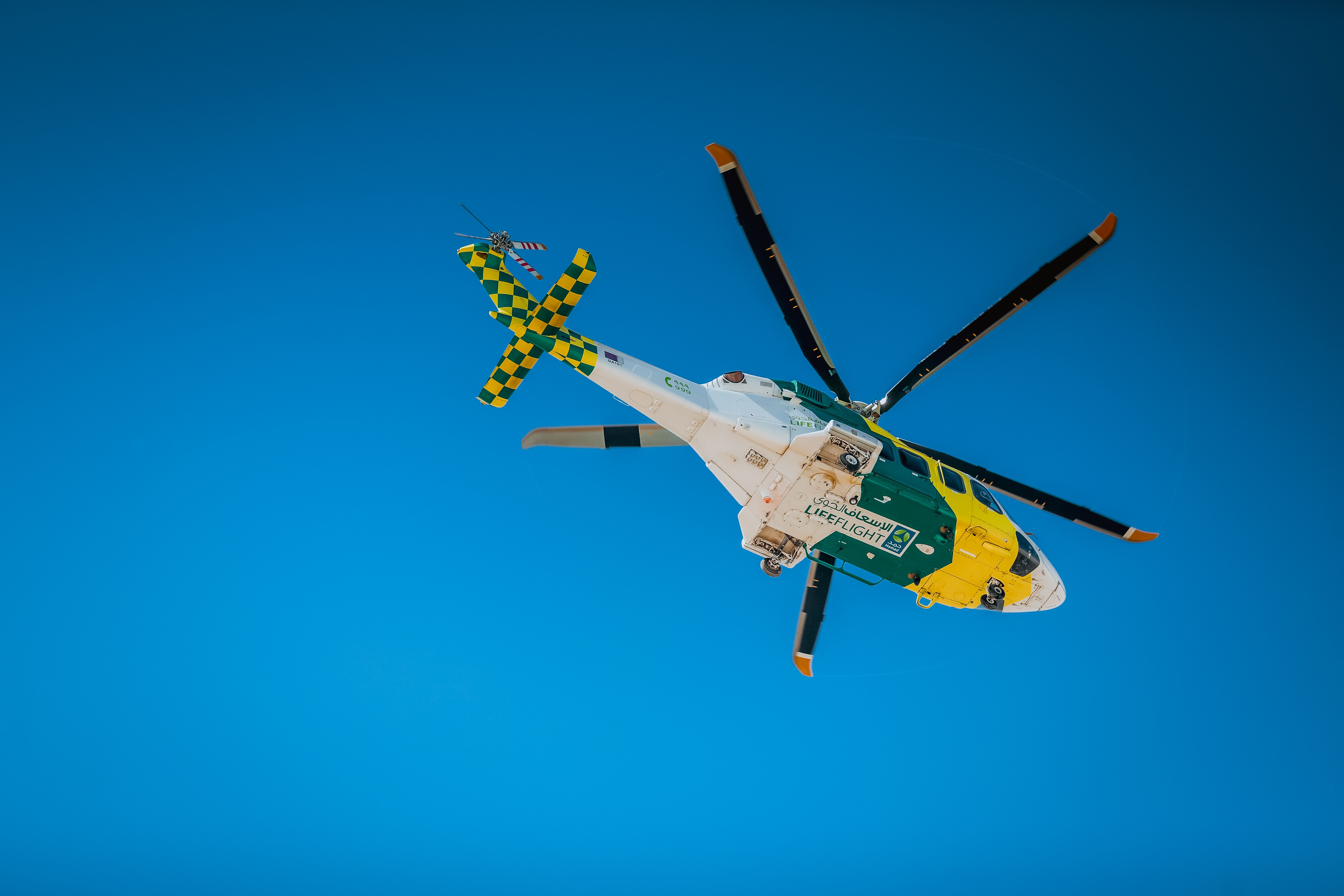 Medical evacuation helicopter landing in a remote mountainous landscape at dusk