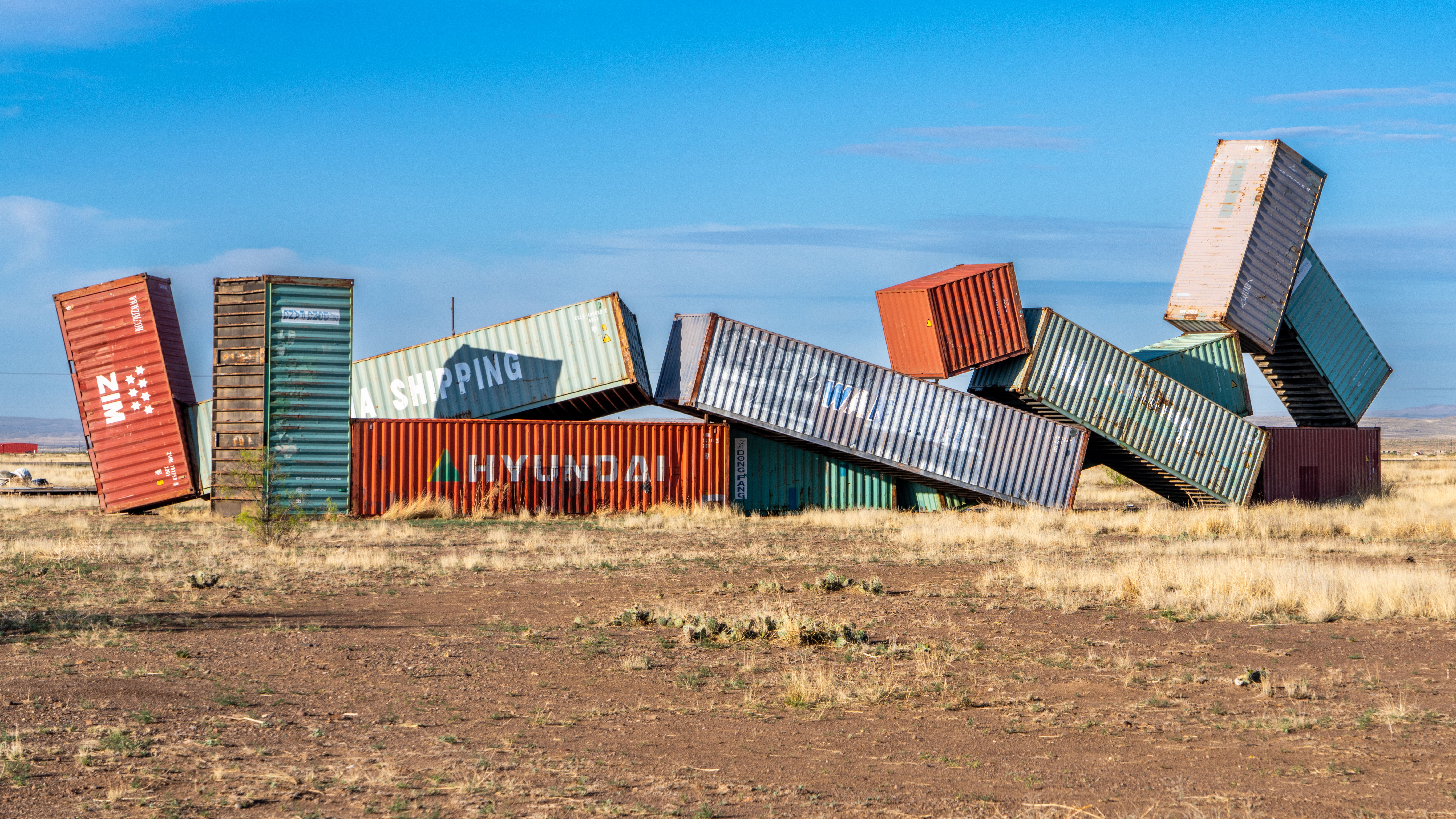 Donald Judd's large-scale aluminum box sculptures inside the Chinati Foundation's artillery sheds in Marfa, Texas, lit by natural light through skylights