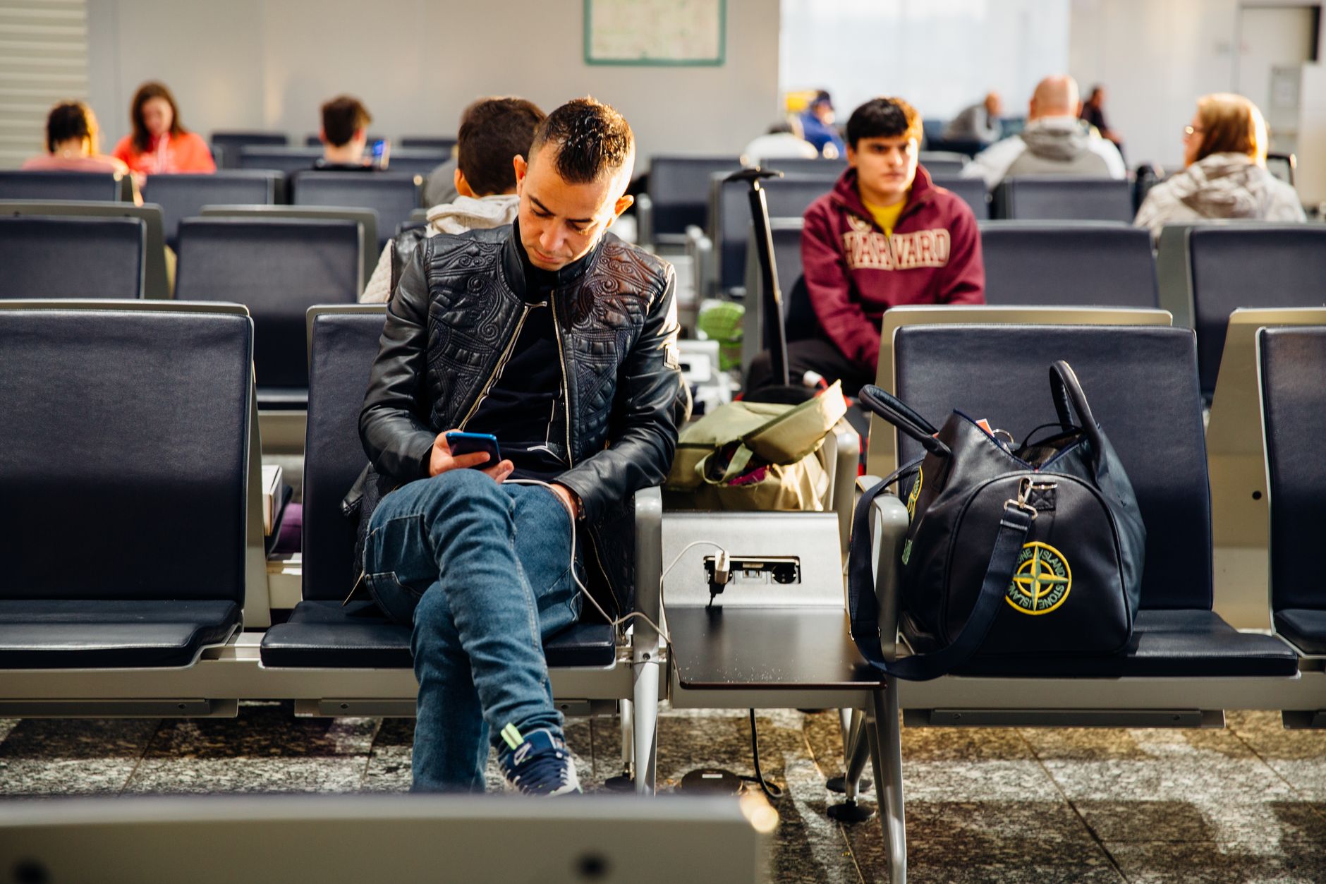 Passenger comparing printed documents with smartphone screen