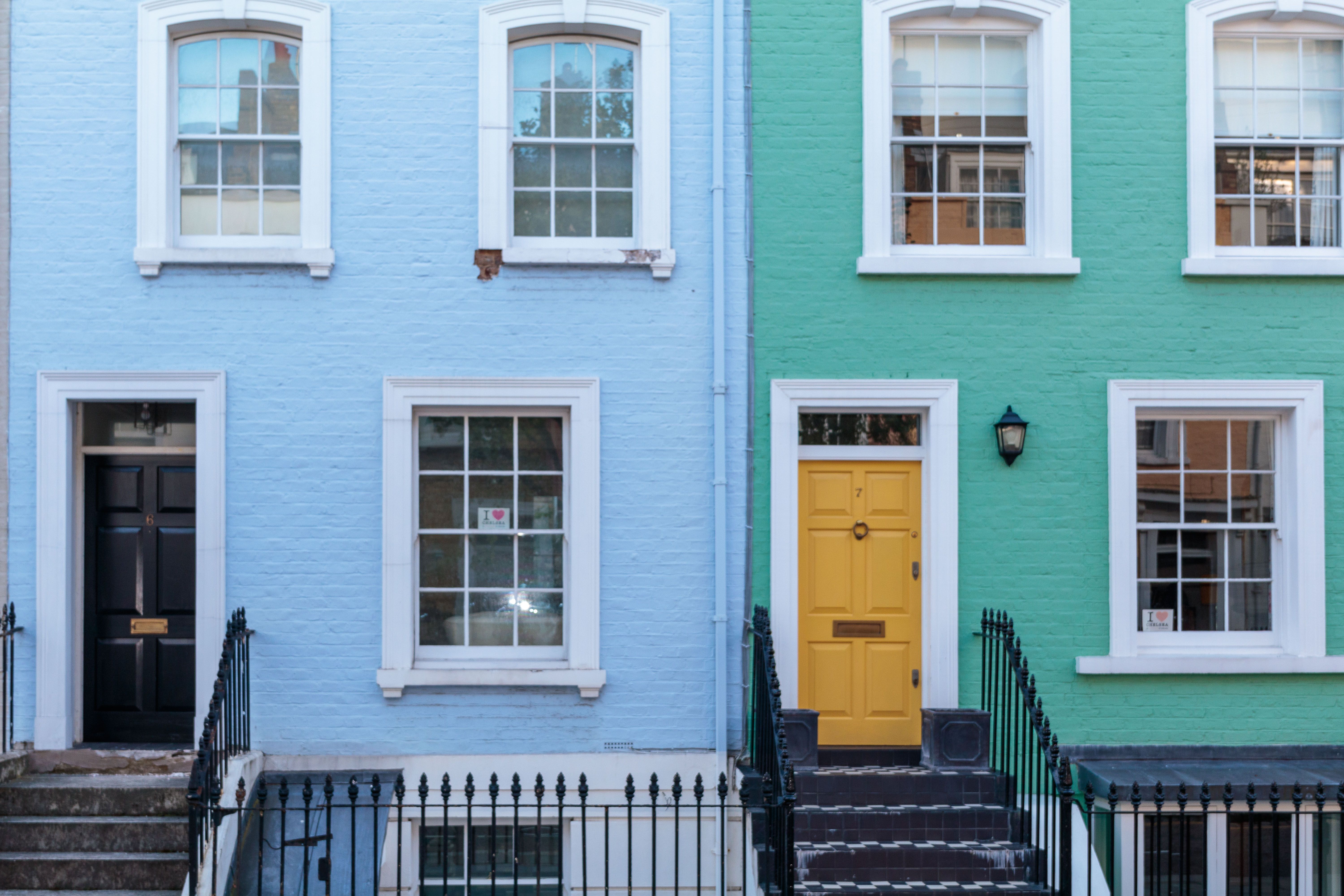 Modern photograph of Charleston's Rainbow Row, a series of brightly painted historic Georgian row houses along East Bay Street on a sunny day