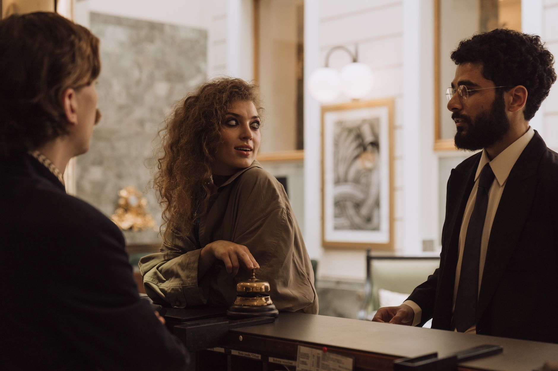 Traveler speaking with hotel staff at service desk