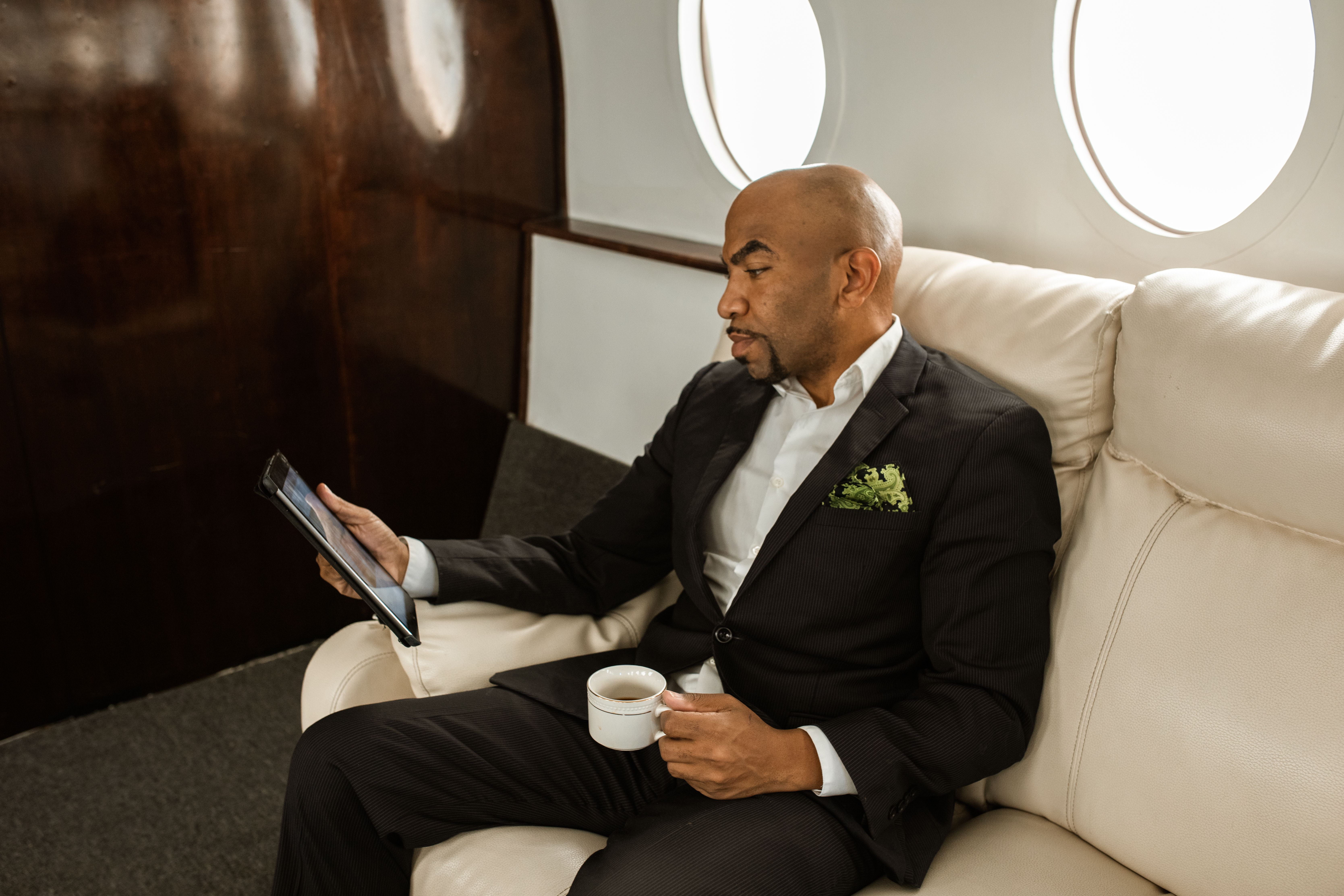 Emirates first class private suite with sliding door, leather seat, and minibar visible onboard