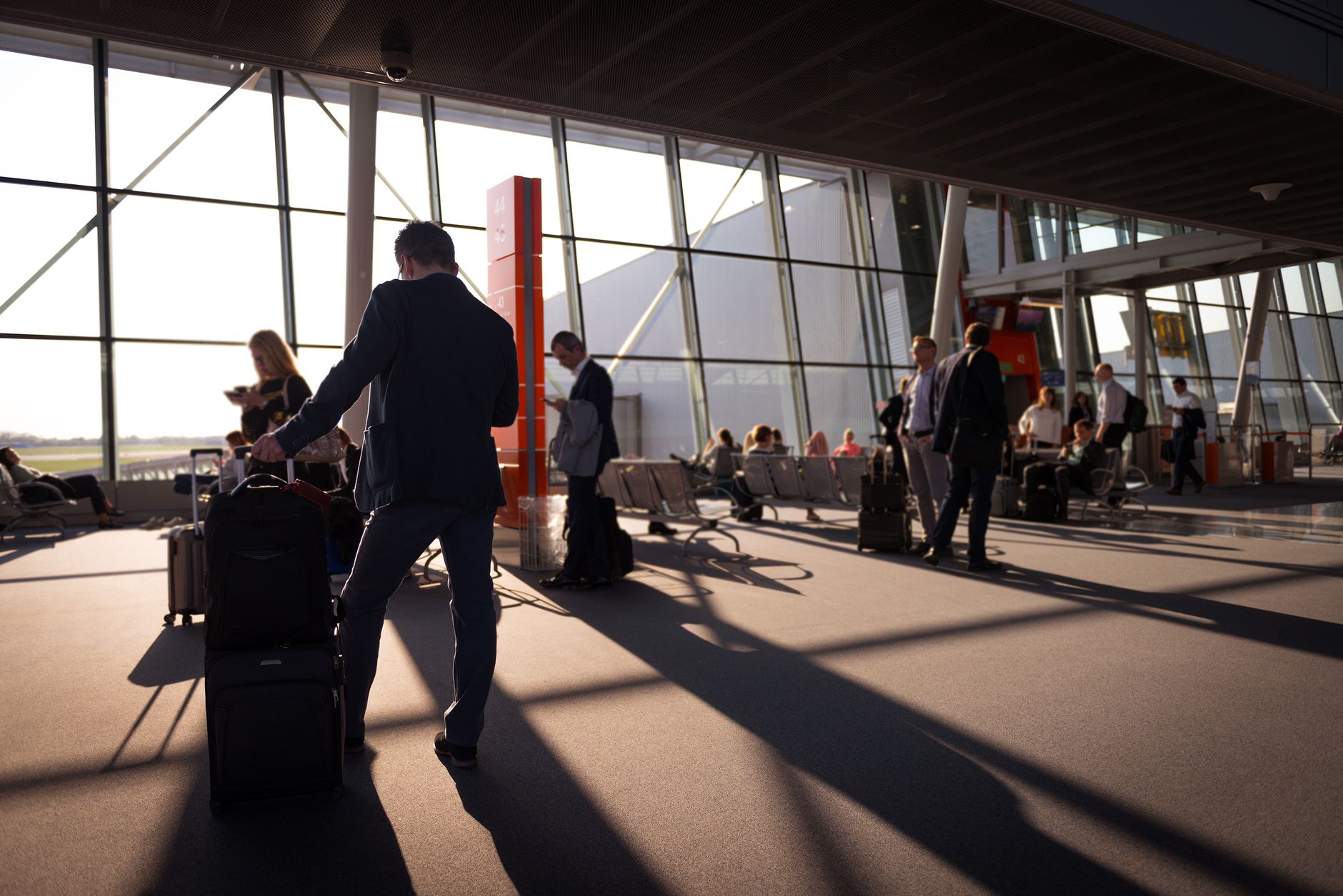 Passenger reviewing travel documents in bright airport terminal