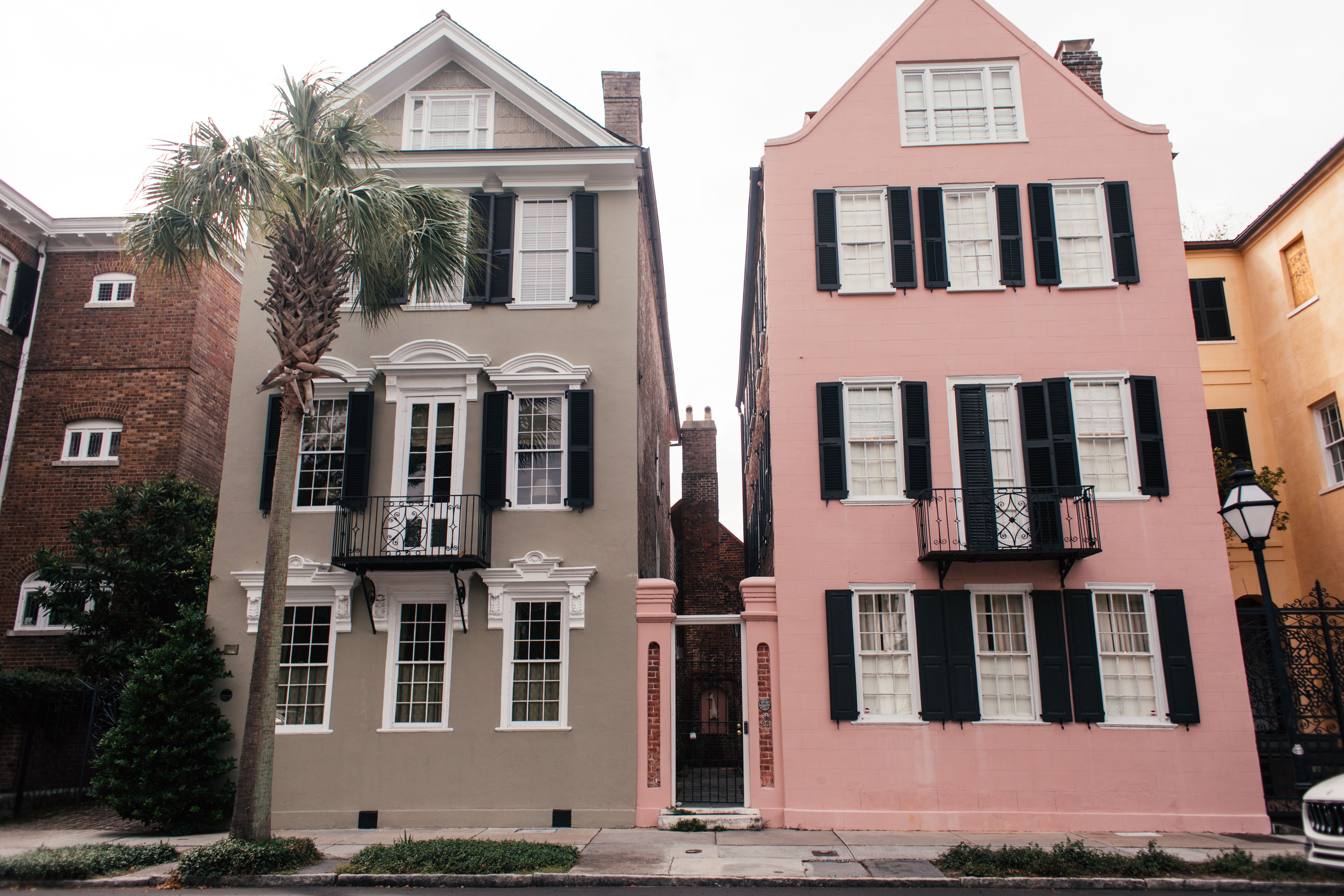 Archival black and white photograph of Charleston's East Bay Street row houses in the 1920s, before modern restoration