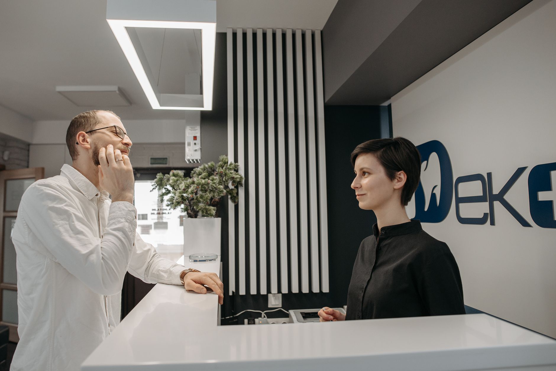Traveler at airport customer service desk speaking with airline agent