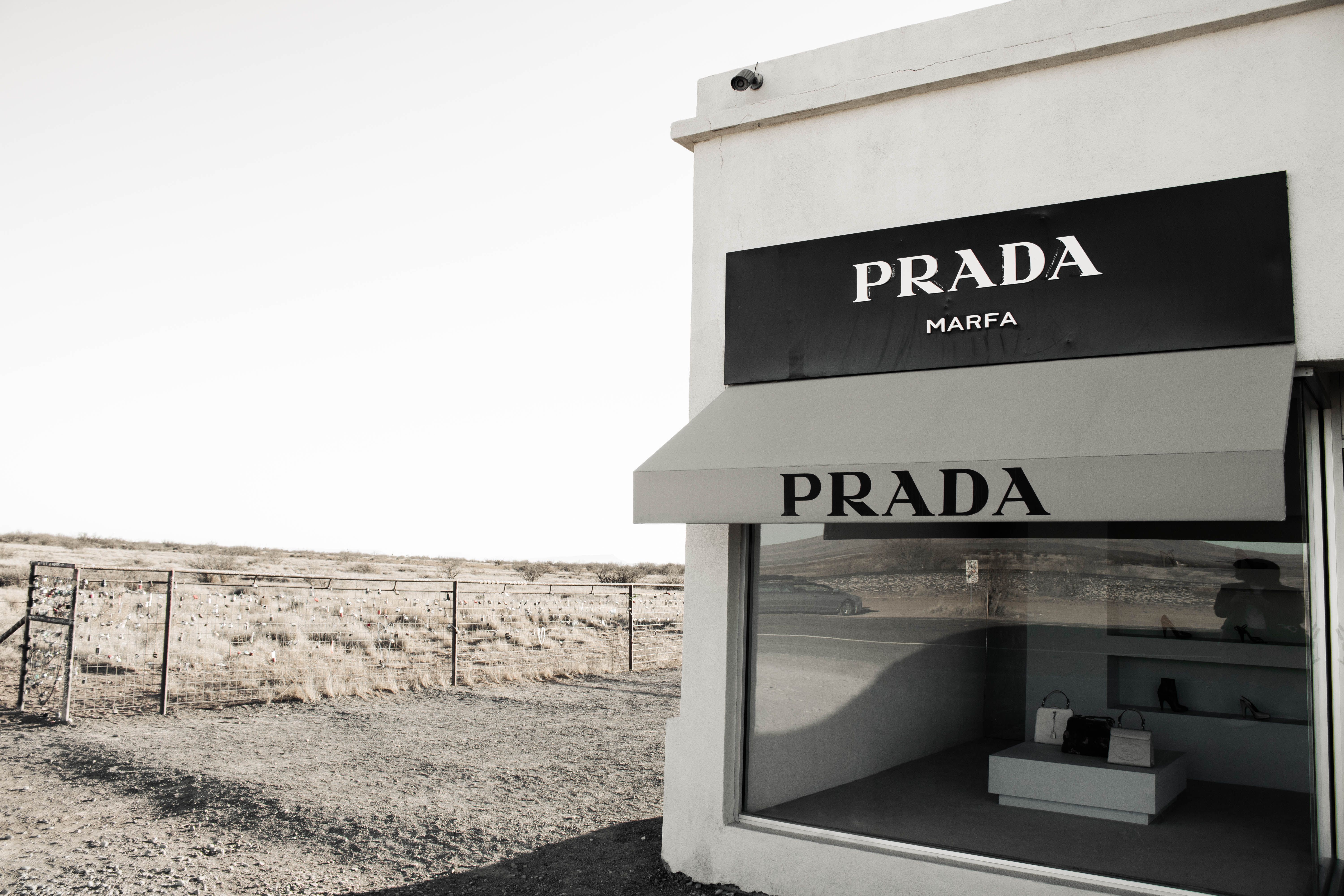 The Prada Marfa art installation — a faux luxury storefront — standing alone in the flat desert landscape along Highway 90 near Marfa, Texas