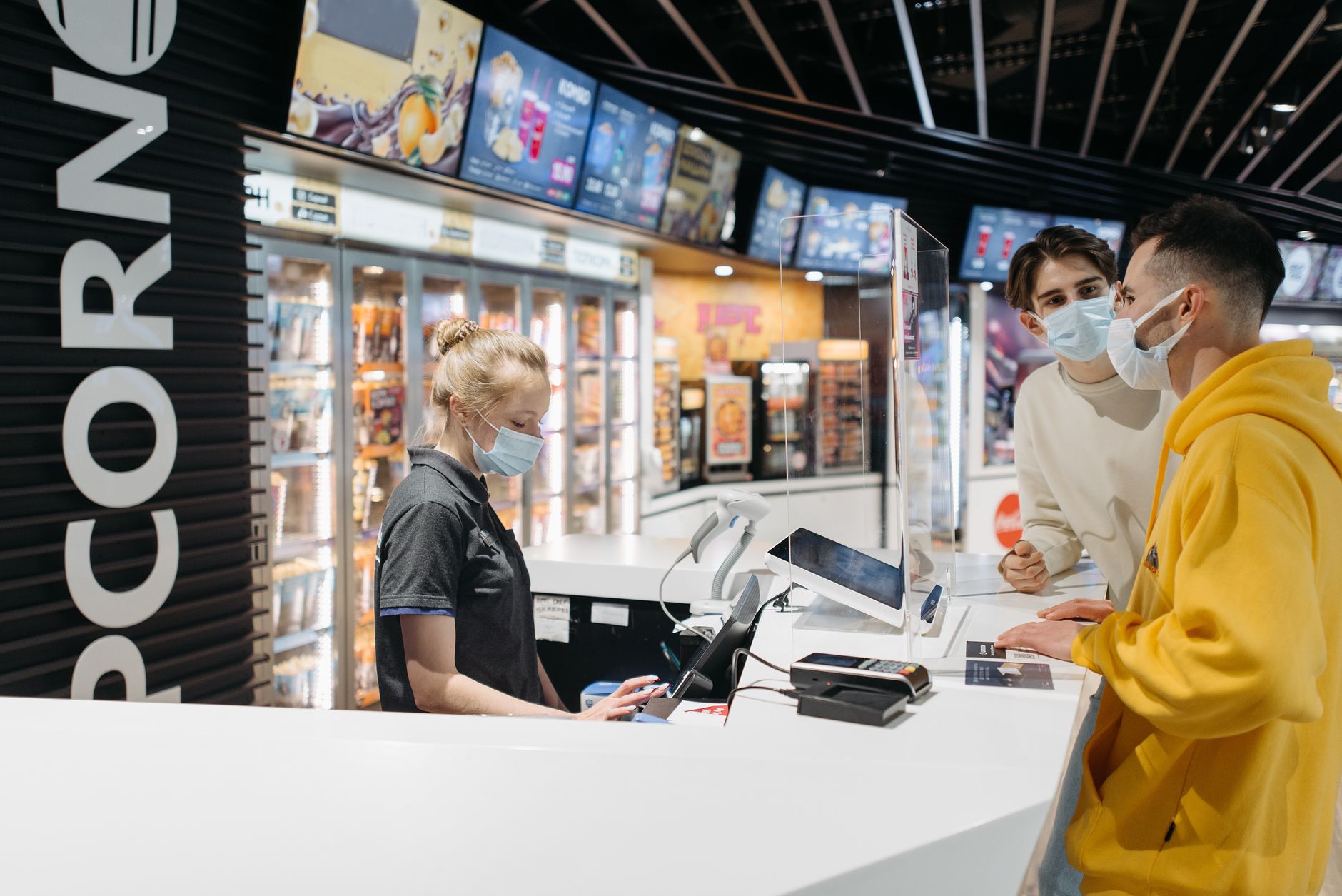 Airline staff assisting traveler at ticket counter