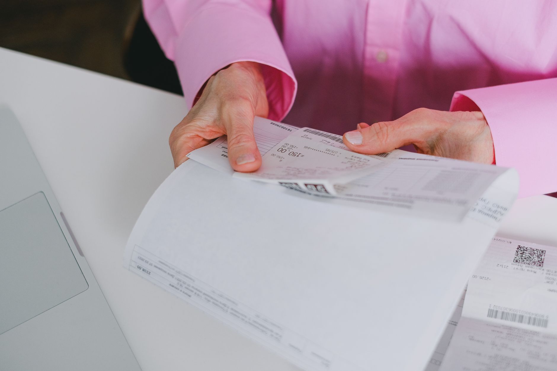 Traveler organizing receipts and documents at airport