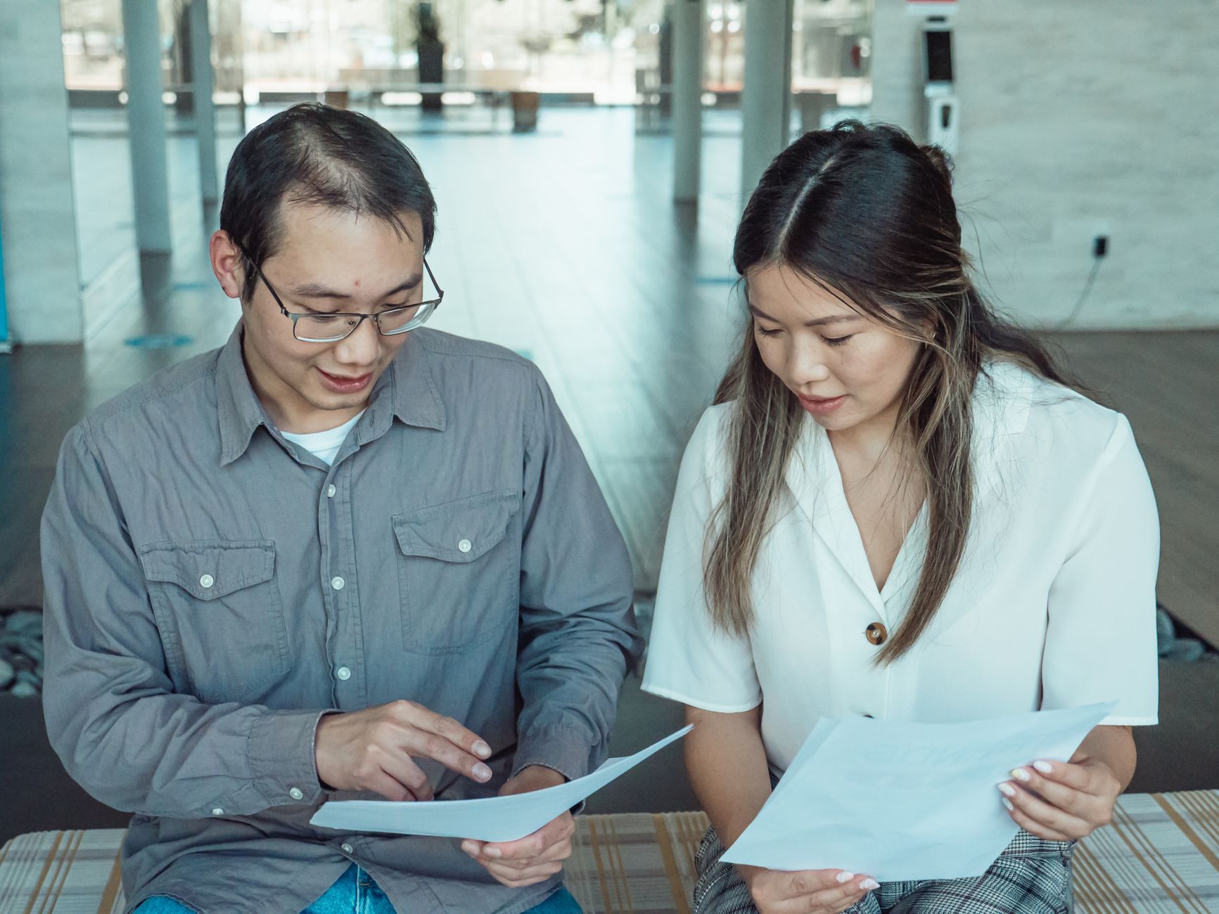 Traveler reviewing travel documents in airport terminal