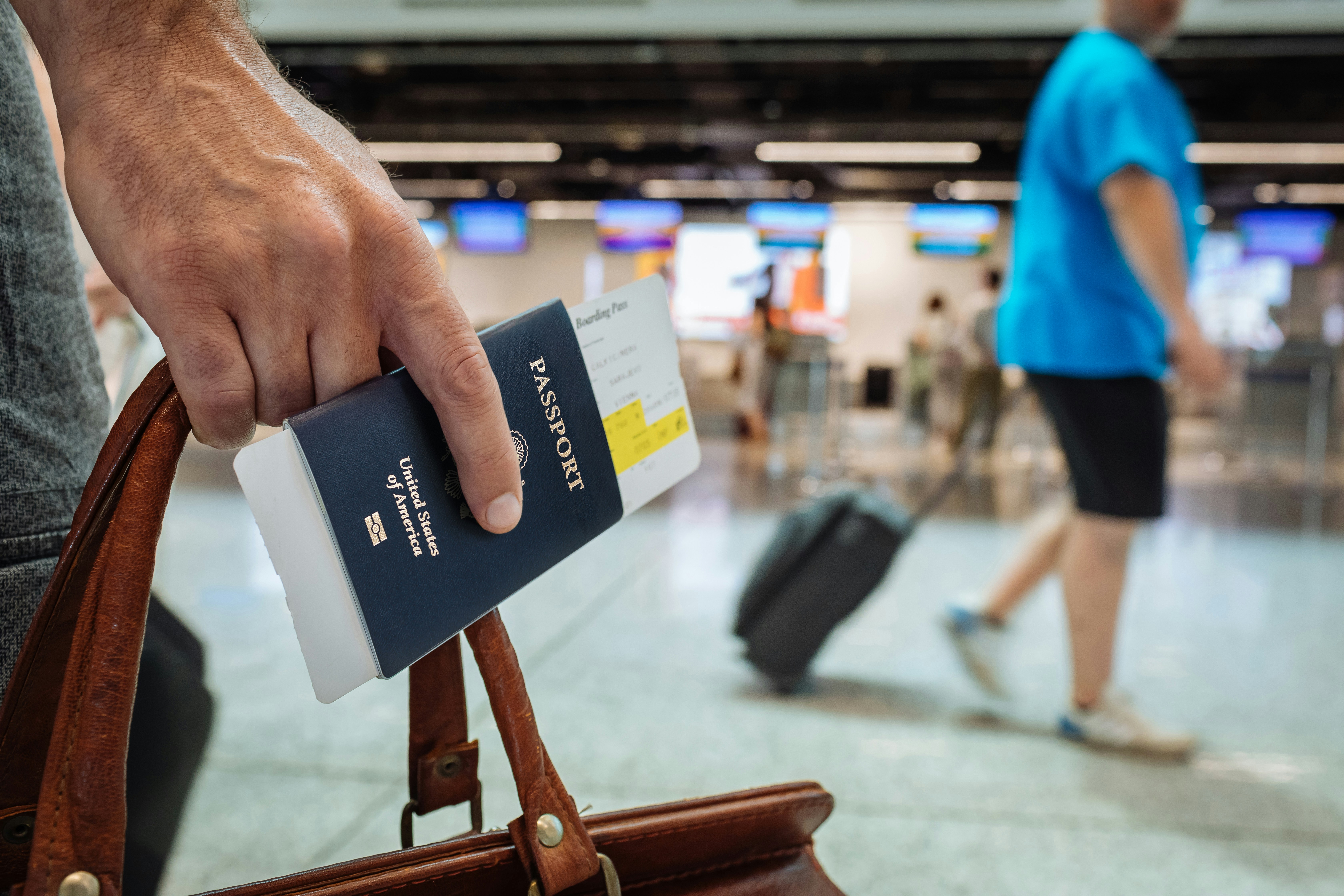 Traveler organizing receipts and documentation at airport terminal
