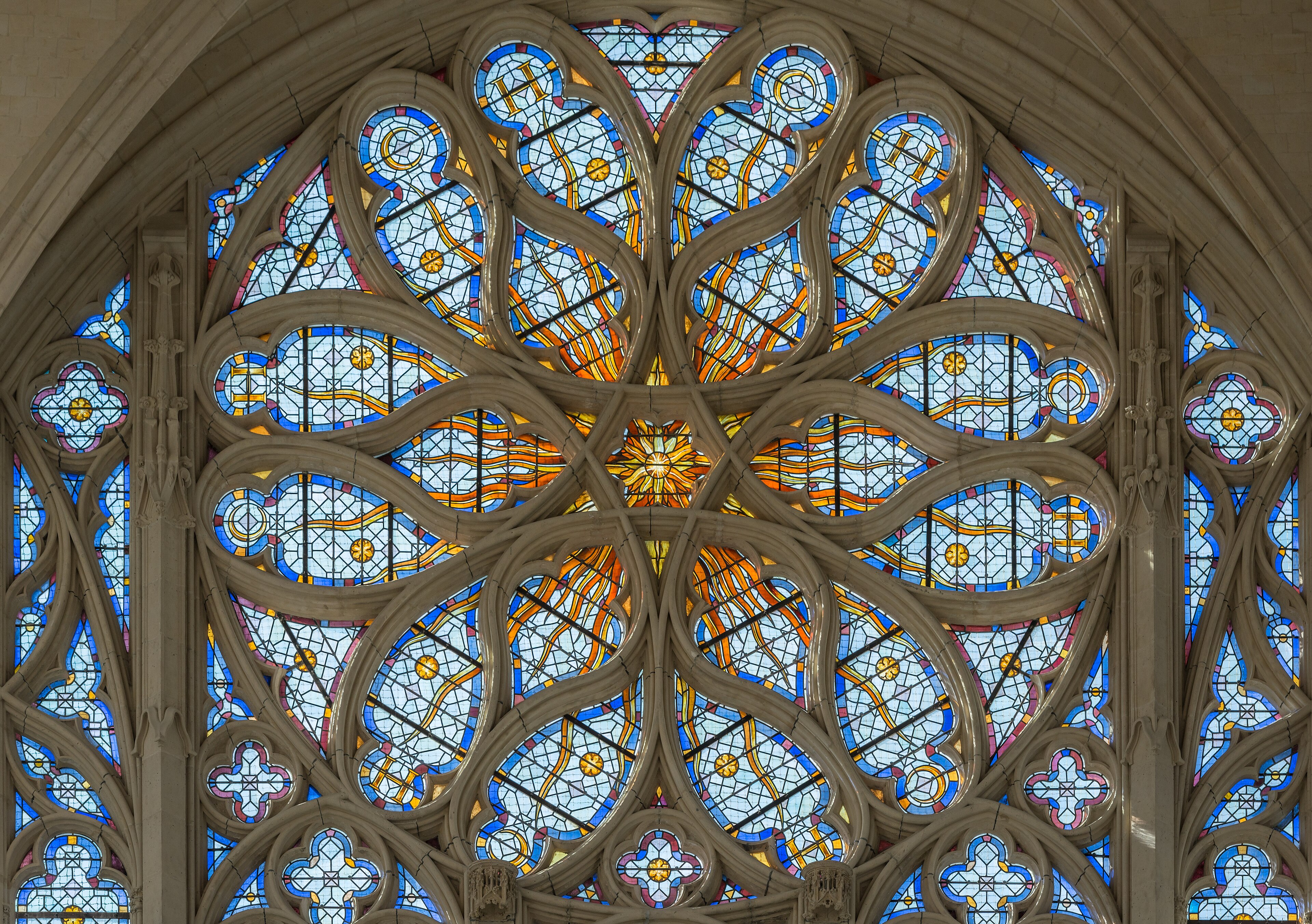 Interior of Sainte-Chapelle in Paris showing floor-to-ceiling medieval stained glass windows in vivid blue and red
